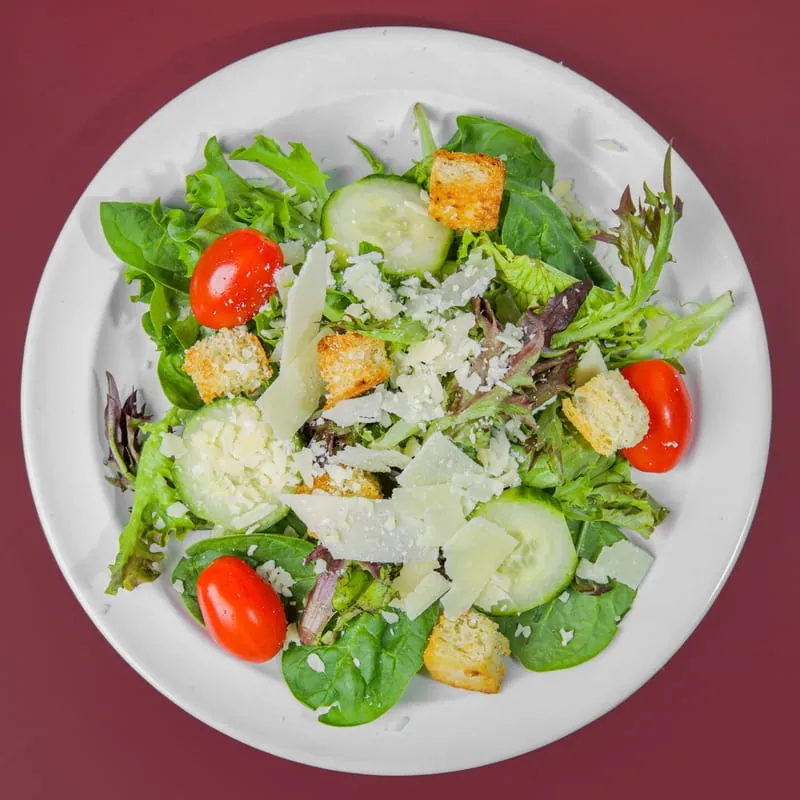 Bella's Salad of spring mix, tomatoes, cucumbers, croutons and Parmigiano