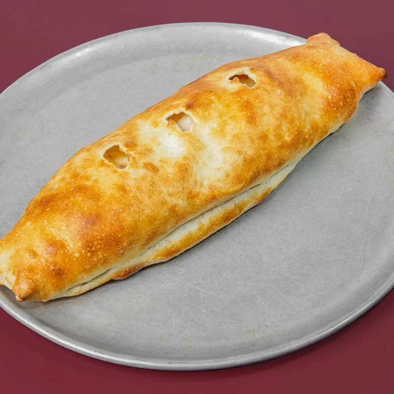 Golden baked pepperoni roll on a pizza pan