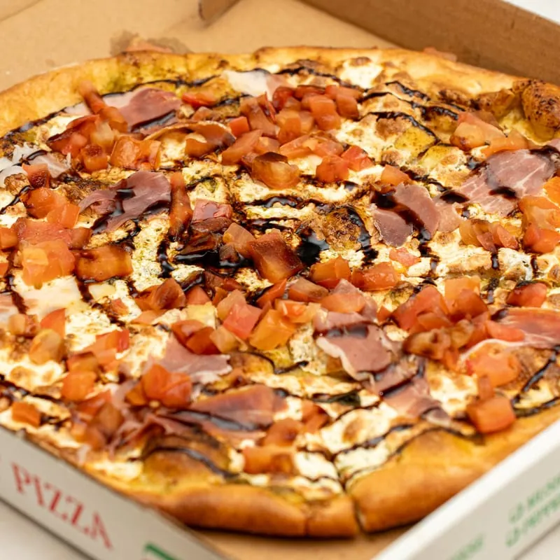 Portofino pizza with prosciutto, tomatoes and balsamic drizzle